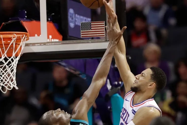 Philadelphia 76ers' Ben Simmons (25) is fouled by Charlotte Hornets' Bismack Biyombo (8) during the first half of an NBA basketball game in Charlotte, N.C., Tuesday, March 19, 2019. (AP Photo/Chuck Burton)
