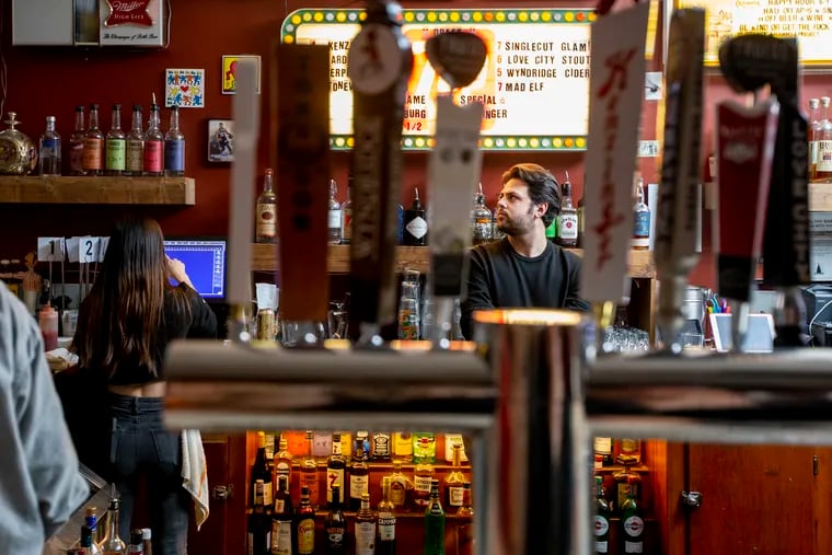 Jacob Cohen stands behind the bar at Sergeant York.