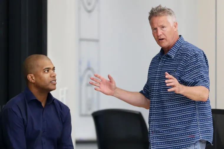 Vice president of player personnel Marc Eversley (left) talks with head coach and interim general manager Brett Brown.