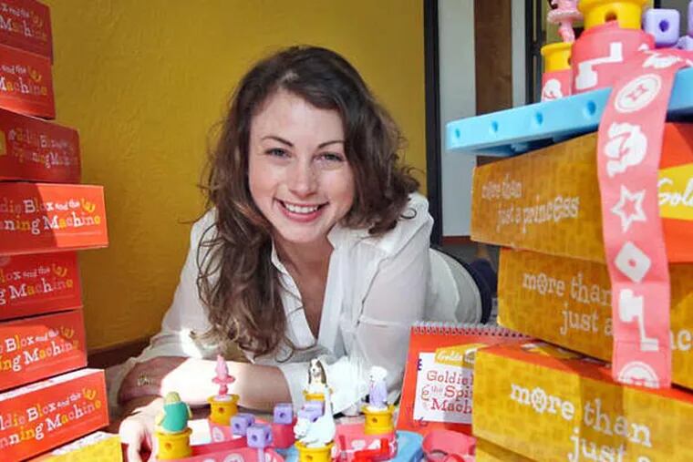 Debbie Sterling, founder of GoldieBlox, Inc., poses with stacks of her new toy for girls called Goldie Blox and the Spinning Machine at her new office in Oakland, California, February 20, 2013. Sterling founded the company last year with a mission to teach young girls basic engineering principles through toys. (Laura A. Oda/Contra Costa Times/MCT)