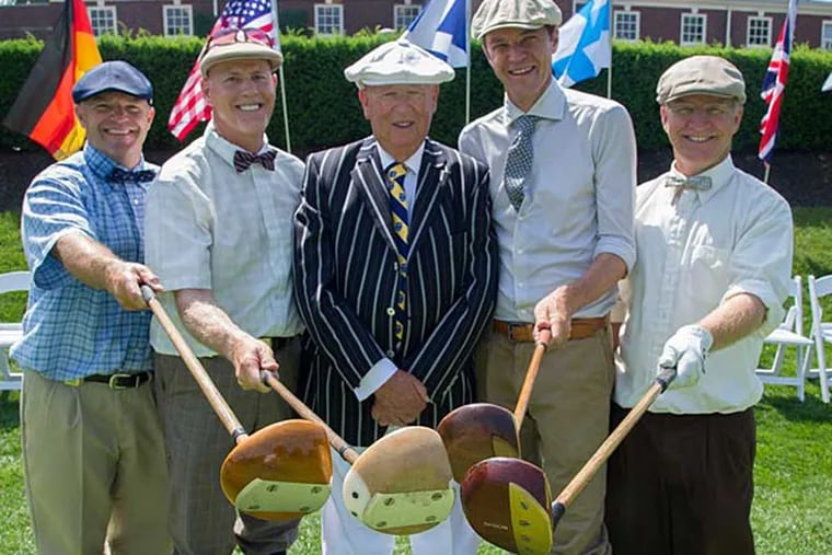 Sporting their knickers, ties and floppy caps, and holding their old-fashioned hickory shaft drivers, are competitors (from left) Craig Stroud, 47, Thomasville, NC; Mark Hollinsworth, 57, Pinehurst, NC; Sir Lionel Freedman, 80, Musselburgh, Scotland, who is the honorary starter for the World Hickory Match Play Championship at the Philadelphia Cricket Club; Paolo Quirici, 46, Switzerland, who is the 2013 World Hickory Open Champion; and Eric Hjortness (cq), 52, Menasha, WI.  Photo taken June 17, 2014. (Clem Murray/Staff Photographer)