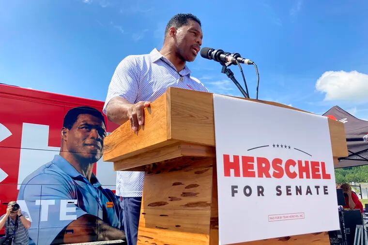 Republican Senate nominee Herschel Walker campaigns in Emerson, Ga., last month. Walker opposes abortion in all cases, including rape and incest. Yet, a former girlfriend alleged Walker paid for her abortion in 2009 and encouraged her to get a second abortion two years later.