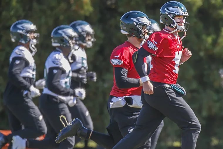 Eagles quarterback Carson Wentz, right, runs with his teammates during warm ups prior to the Eagles practice on Thursday October 25, 2018, in preparation for their game in London against the Jaguars.