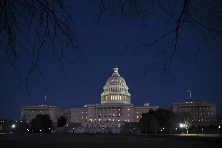 The Capitol is illuminated in Washington, Friday evening, Jan. 19, 2018.