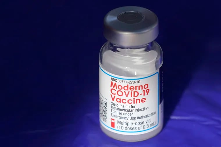A vial of the Moderna COVID-19 vaccine rests on a table at a drive-up mass vaccination site in Puyallup, Wash., south of Seattle.