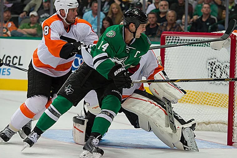 Stars left wing Jamie Benn and Flyers defenseman Nicklas Grossmann chase the puck. (Jerome Miron/USA Today Sports)