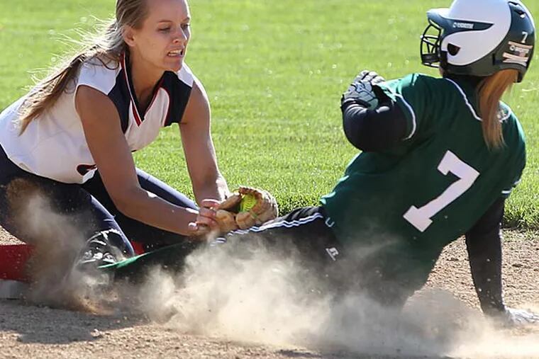 East's Jess Haug, left, tags out Pennridge's, Allison Horne in
the fifth inning as Horne tried a stretch a single into a double. (Michael Bryant/Staff Photographer)