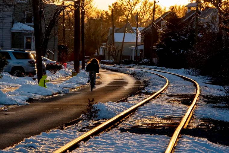 The sun sets upon streets in Moorestown on Monday. Tuesday the region could get a dusting, but forecasters are calling for the possibility of  more 'plowable snow' Wednesday night into Thursday, with more on Friday.