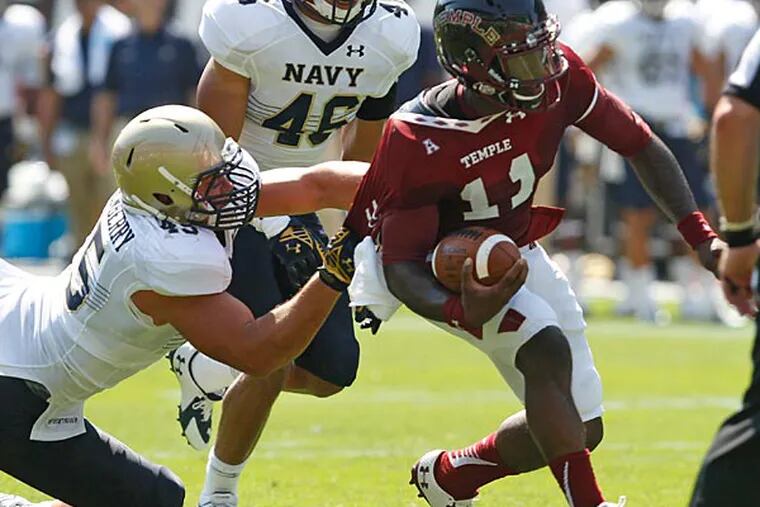 Temple quarterback P.J. Walker is dragged from behind by Navy's Paul Quessenbery. (Ron Cortes/Staff Photographer)