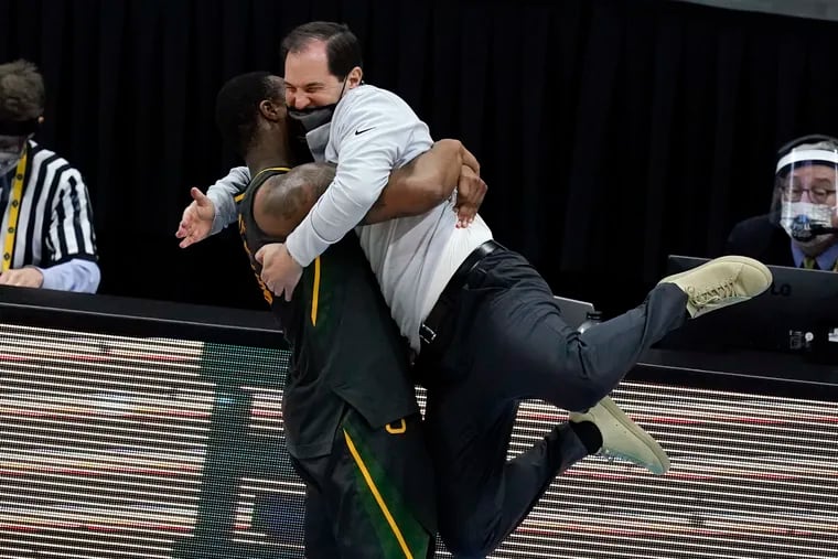 Baylor head coach Scott Drew gets a hug from guard Mark Vital at the end of the championship game against Gonzaga.
