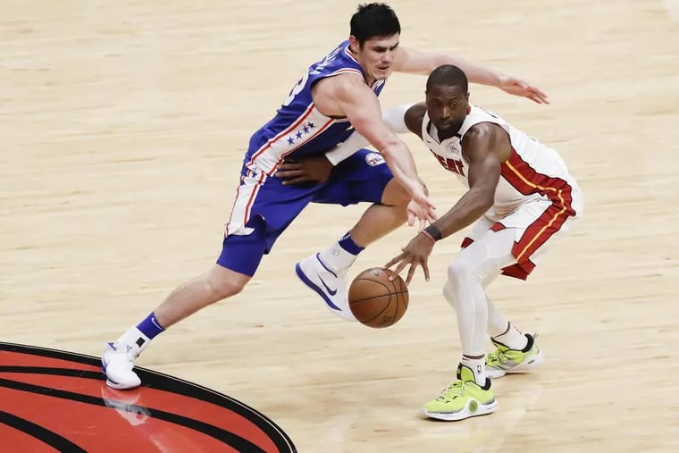 Sixers forward Ersan Ilyasova defends Heat guard Dwyane Wade during Game 4 of the Eastern Conference quarterfinals on Saturday.