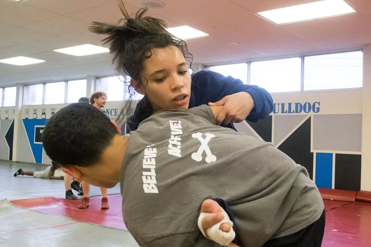 Mariana Bracetti wrestler Tatyana Ortiz works out with practice partner Renaldo Garcia.  ED HILLE / Staff Photographer