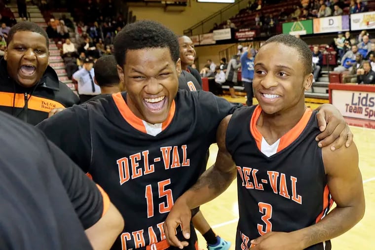 Del-Val Charter players # 15 Waheem Lowman and # 3 Semaj Motley celebrate after winning the Del-Val Charter vs Neumann Goretti H.S. District 12 Class AAA boys basketball final at St. Joseph's University on Feb. 24, 2016. Del-Val won 81-79.   ELIZABETH ROBERTSON / Staff Photographer