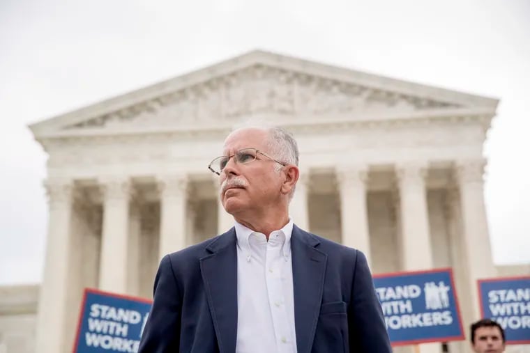 Plaintiff Mark Janus stands outside the Supreme Court after the court ruled that states can't force government workers to pay union fees.
