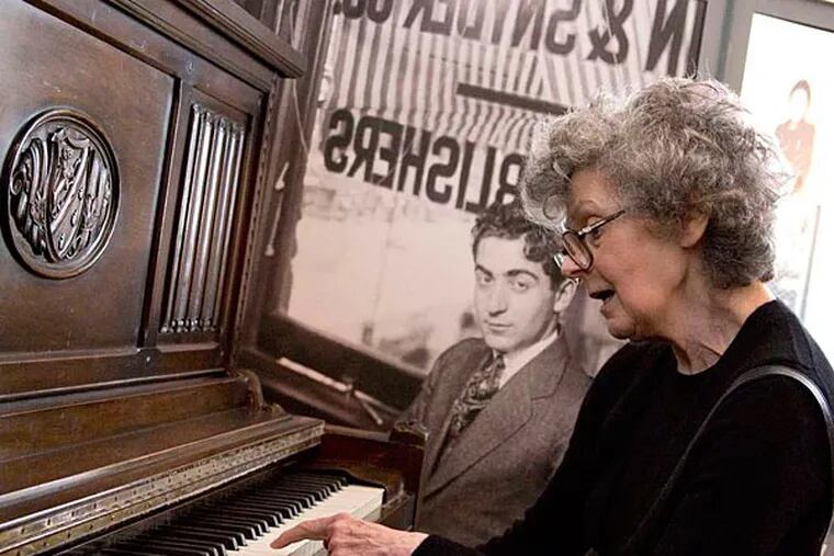 Linda Emmet, daughter of Irving Berlin, plays on one of her father's pianos at the museum. Berlin, then named Israel Baline, fled Russia at age 5 with his family in 1893.