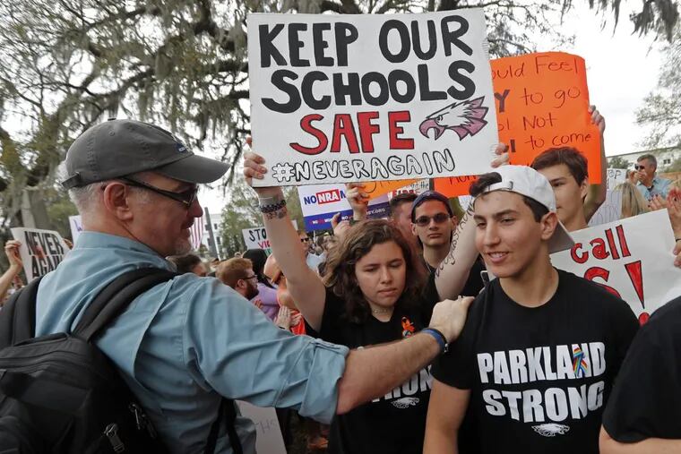 Student survivors from Marjory Stoneman Douglas High School are greeted as they arrive at a rally for gun control reform on the steps of the state capitol, in Tallahassee, Fla.