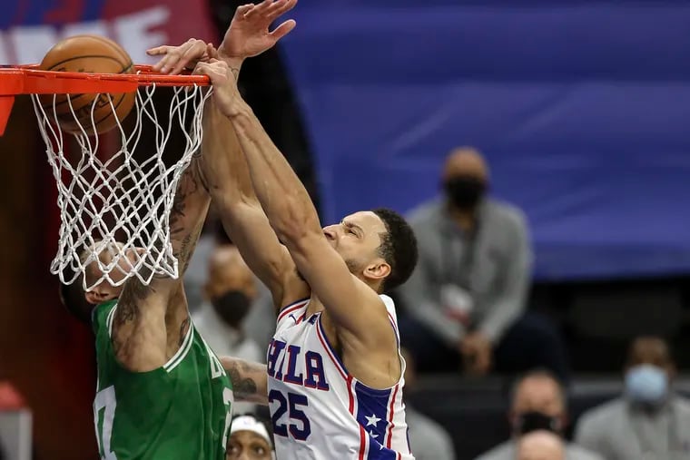 The Sixers' Ben Simmons dunks over the Celtics' Daniel Theis  during the third quarter.