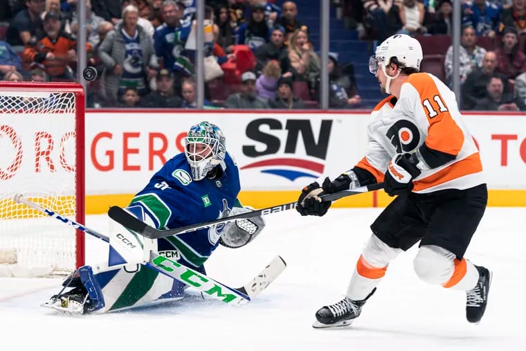 Philadelphia Flyers' Travis Konecny, right, puts a backhand shot during the second period on Saturday. Konecny failed to score but recorded an assist.