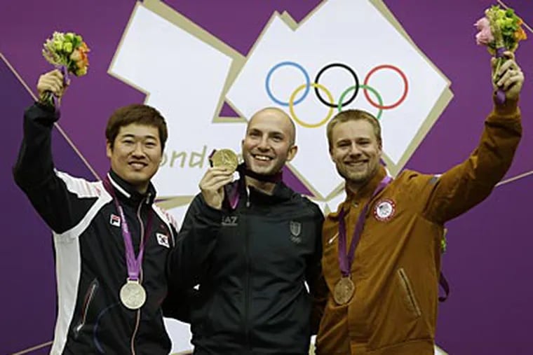Matthew Emmons (right) won the bronze medal in the men's 50-meter rifle 3 positions event in London. (Rebecca Blackwell/AP)