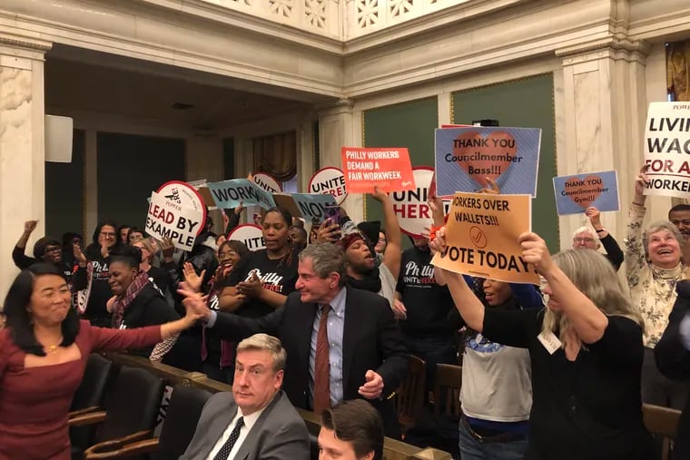 Councilmember Helen Gym (far left) rejoices with other supporters of the "Fair Workweek" scheduling bill after Council voted to approve it Thursday afternoon.