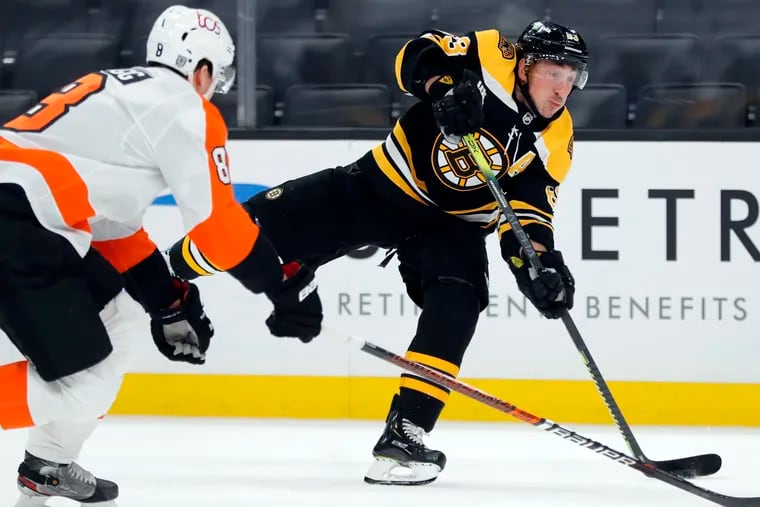 With the Flyers' Robert Hagg defending, Boston's Brad Marchand (63) takes a shot in Saturday's 6-1 Bruins win. Boston was 3 for 4 on the power play.