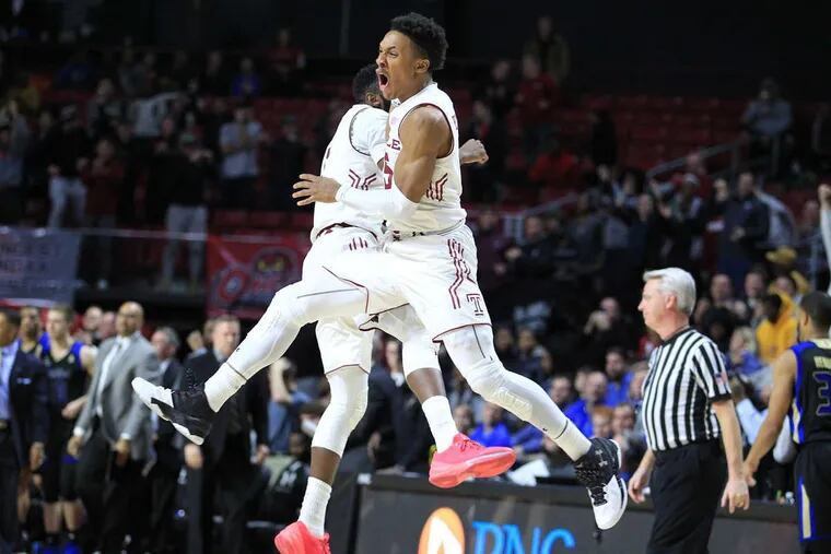 Josh Brown, left, and Nate Pierre-Louis of Temple celebrate after their 59-58 victory over Tulsa at the Liacouras Center on Wednesday.
