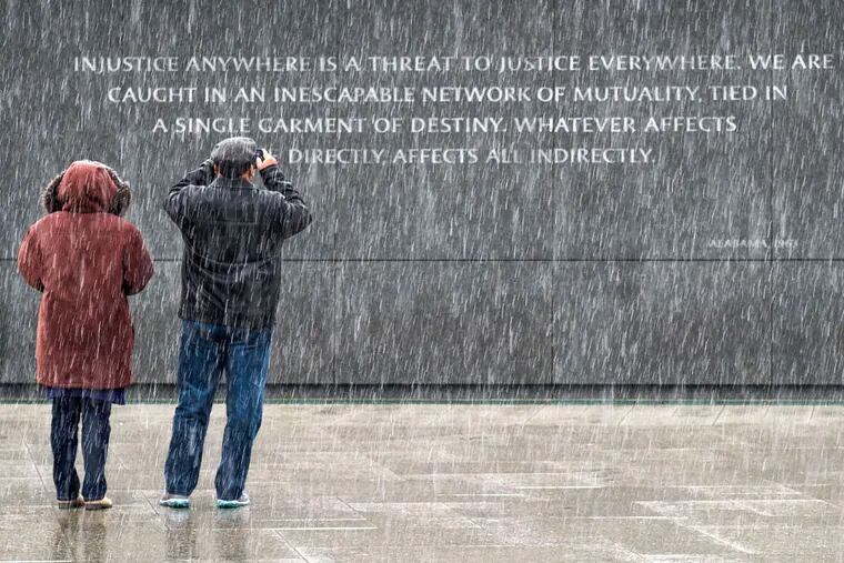 Visitors to the Martin Luther King Jr. Memorial in Washington photographed a quotation etched there on the eve of Monday’s federal holiday honoring the slain civil rights leader.