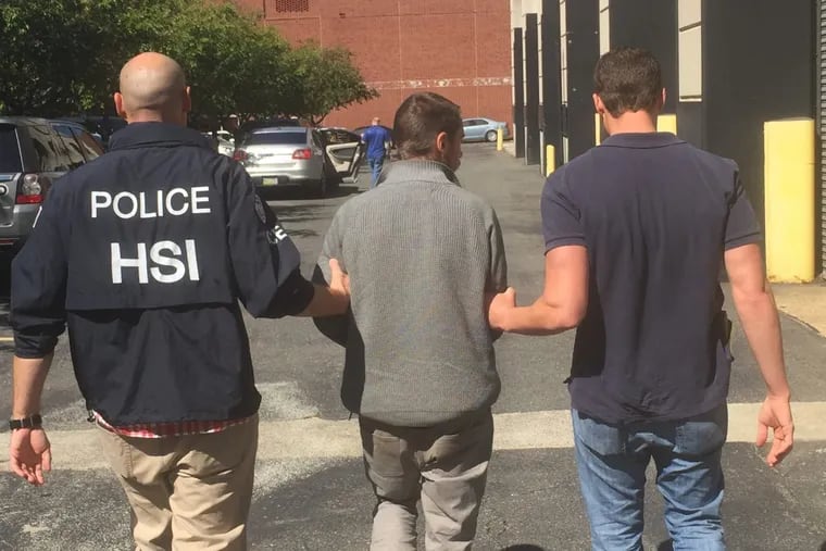 Belgian fugitive Vincent Didler Jean-Marie Gilbert Simonon is escorted by federal agents after his arrest at 30th Street Station.
