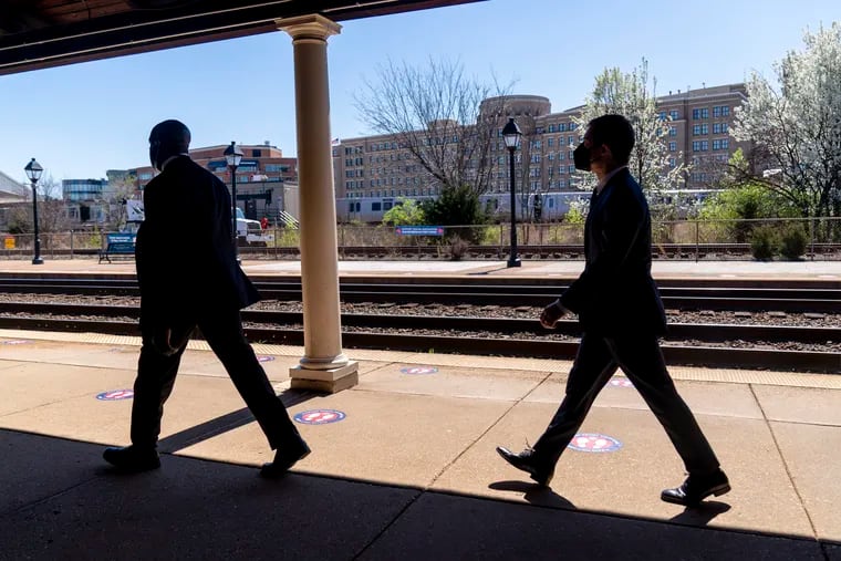 Transportation Secretary Pete Buttigieg, right, departs a news conference to announce the expansion of commuter rail in Virginia at the Amtrak and Virginia Railway Express (VRE) Alexandria Station in Alexandria, Va.