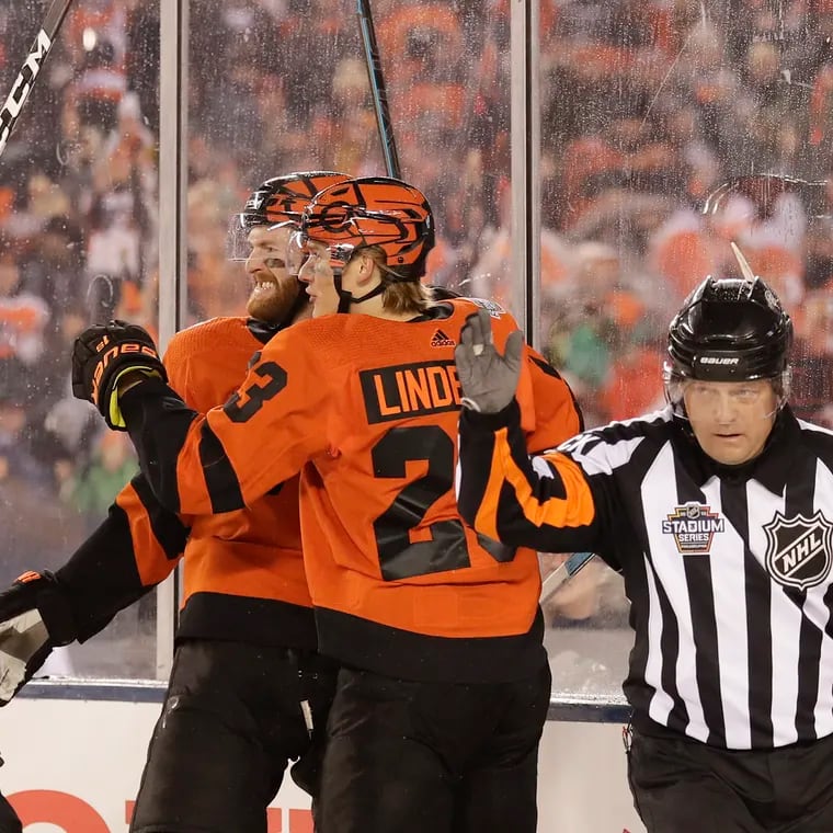 Flyers center Sean Couturier (middle) celebrates his first-period goal at the 2019 Stadium Series at Lincoln Financial Field.
