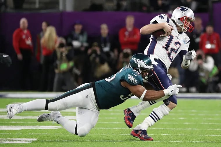 The Eagles’ Brandon Graham tackling Patriots quarterback Tom Brady during the second quarter Sunday.
