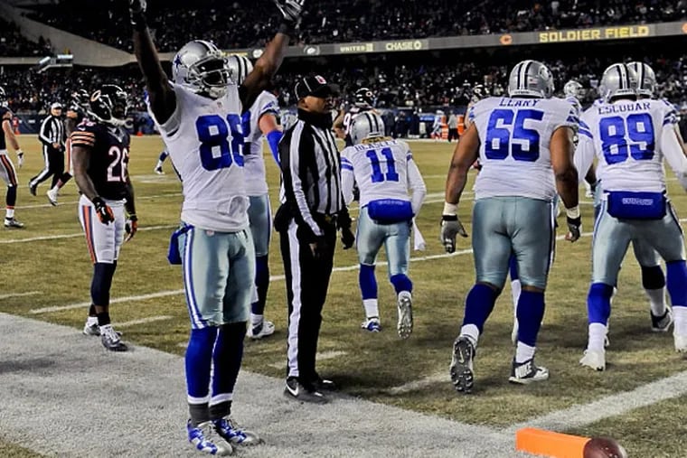 Dallas Cowboys wide receiver Dez Bryant (88) raises his arms after Dallas Cowboys wide receiver Cole Beasley (11) scores a touchdown in the second half of their game against the Chicago Bears at Soldier Field. (Matt Marton/USA TODAY Sports)