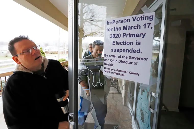 Jefferson County Elections officials arrive to pack up the polling place at Our Lady of Lourdes church in Wintersville, Ohio, Tuesday, March 17, 2020. Ohio's presidential primary was postponed Tuesday amid coronavirus concerns. (AP Photo/Gene J. Puskar)
