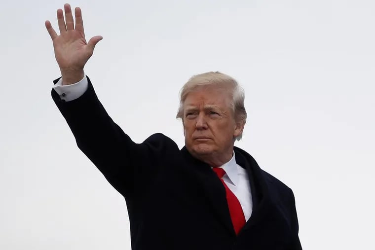 President Donald Trump waves as he boards Air Force One Friday at Andrews Air Force Base, Md., en route to Palm Beach and his Christmas break at Mar-a-Lago.