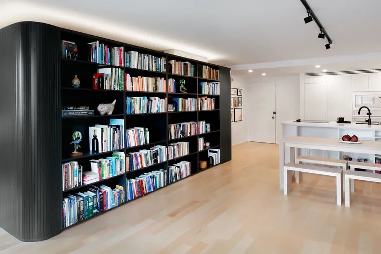 Olivia Walling hired architect Chris Greenawalt of Bunker Workshop and contractor Vincent Novello to open up and reimagine her 850-square-foot space. In the center, they built a pod around an existing structural column that houses Walling's extensive book collection, a coat closet, art supply storage, and an alcove bed.