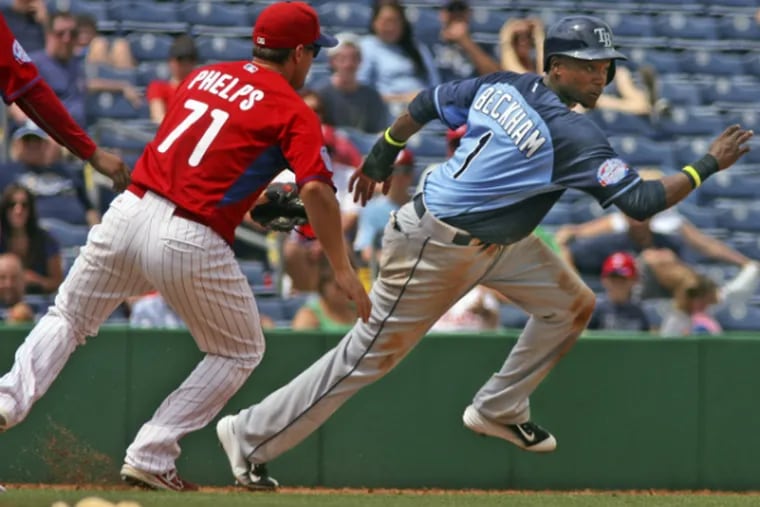 Phillies' Cord Phelps tries to catch Rays' Tim Beckham in a rundown in yesterday's game. (Associated Press)