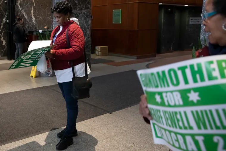 Teralynn Turner, left, of Mt. Airy, stands in the lobby of 100 S. Broad St. in support of Philadelphia Sheriff Jewell Williams on Friday, April 05, 2019. Philadelphia's Democratic City Committee revoked its endorsement of Williams for reelection because three sexual-harassment complaints have been made against him.