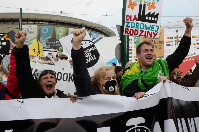 Climate activists shout slogans as they stop in front of the COP24 UN Climate Change Conference venue during the March for Climate in a protest against global warming in Katowice, Poland, Saturday, Dec. 8, 2018. (Alik Keplicz / AP)