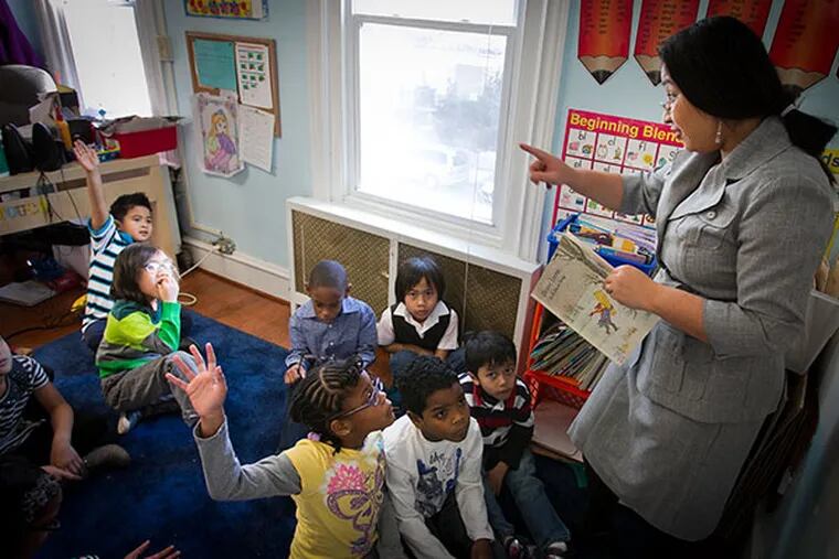 First-grade teacher Savorn Touch (right) talks with students at the Logan Hope School, a small school that caters to Philly's Cambodian community. ( ALEJANDRO A. ALVAREZ / STAFF PHOTOGRAPHER )