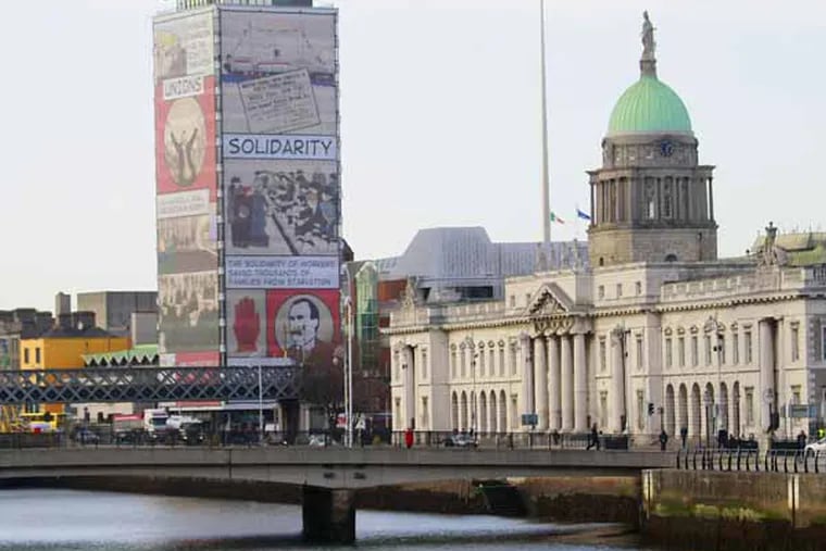 A general view of the customs house building and the River Liffey in the centre of Dublin, Ireland,  Friday,Dec. 13, 2013. On Sunday, Ireland officially ends its reliance on a 67.5 billion-euro ($93 billion) loan program that European governments and the International Monetary Fund provided in 2010 to save the Irish from national bankruptcy. Ireland's finance chief says the country's exit from its international bailout this week should be celebrated as a eurozone triumph, but won't mean an end to austerity for the debt-battered Irish.  (AP Photo/Peter Morrison)