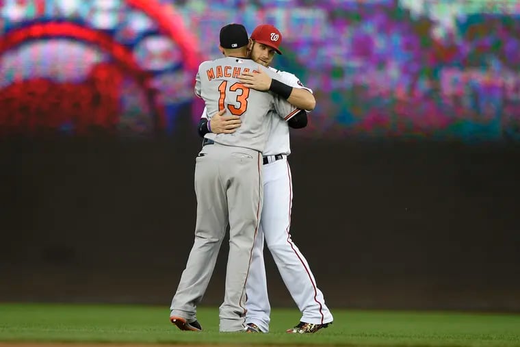 The Nationals' Bryce Harper (right) greets Orioles third baseman Manny Machado before a game in 2015.
