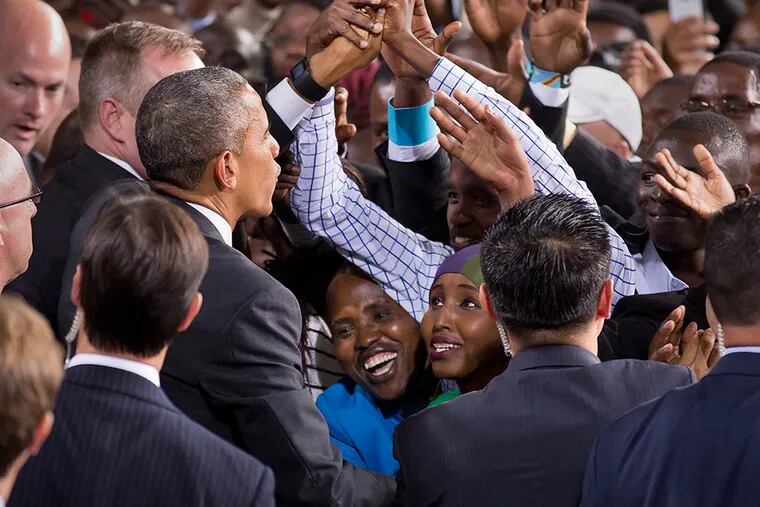 Two Kenyan women look up as President Barack Obama reaches out to shake the hands of the crowd, as he departs after delivering a speech at the Safaricom Indoor Arena in the Kasarani area of Nairobi, Kenya Sunday, July 26, 2015. Obama is traveling on a two-nation African tour where he will become the first sitting U.S. president to visit Kenya and Ethiopia. (AP Photo/Ben Curtis)