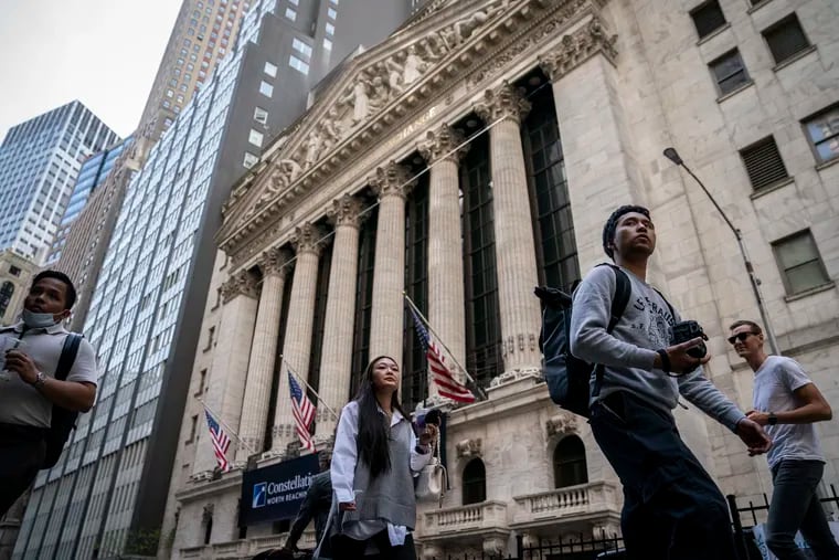 Pedestrians pass the New York Stock Exchange, Thursday, May 5, 2022, on Wall Street. (AP Photo/John Minchillo)