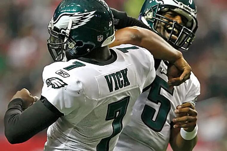 Michael Vick and Donovan McNabb had plenty to celebrate as the Eagles routed the Falcons in Atlanta. (Ron Cortes/Staff Photographer)
