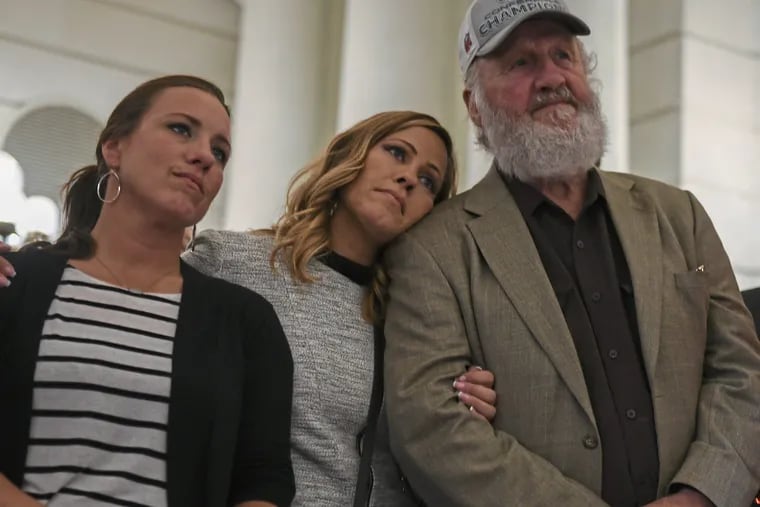 Patty Fortney-Julius, from second left, sister Carolyn Fortney and father Edward Fortney listen to speakers during a news conference at the Pennsylvania state Capitol in Harrisburg, Pa., Monday, Sept. 24, 2018. A proposal to give victims of child sexual abuse a two-year window to sue over allegations that would otherwise be too old to pursue was overwhelmingly approved by the state House on Monday, as supporters cheered from the gallery. (Steve Mellon/Pittsburgh Post-Gazette via AP)