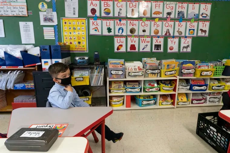 A student wears a face mask while seated at a proper distance from classmates in a kindergarten class on Oct. 20, 2020 at School 16 in Yonkers, N.Y. Kindergarten enrollment in public schools is seeing a decline around the country during the pandemic.