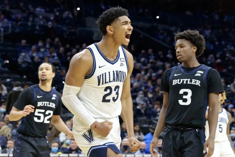 With Butler’s 52 Jair Bolden and 3 Chuck Harris looking on, Villanova’s 23 Jermaine Samuels celebrates after he was fouled in the second half half of the Butler University vs. Villanova University NCAA mens basketball game at the Wells Fargo Center in Phila., Pa. on Jan. 16, 2022.