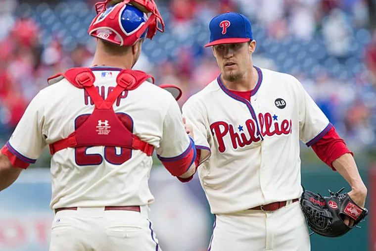 Philadelphia Phillies relief pitcher Ken Giles (53) and catcher Cameron Rupp (29) celebrate a victory over the Chicago Cubs at Citizens Bank Park. The Phillies won 7-4.
