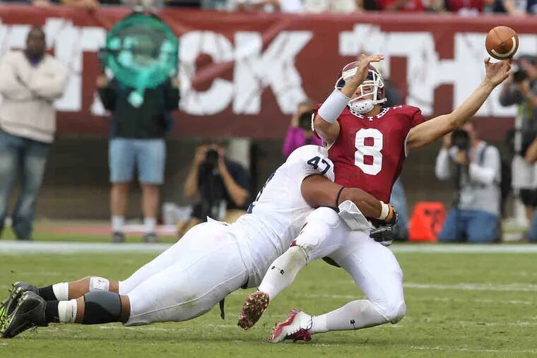 Penn State's Jordan Hill brings down Temple quarterback Mike Gerardi as Gerardi attempts to pass in the fourth quarter. Gerardi's two late interceptions hurt the Owls' chances to win.