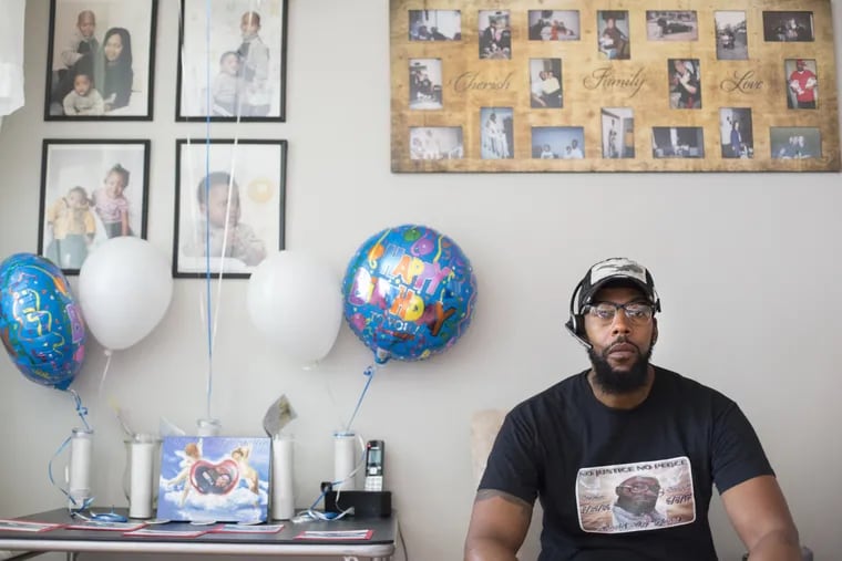 Thomas Jones next to birthday balloons and photos of his family in honor of his son, David Jones&#039;, 31st  birthday today, in his home in Olney Wednesday, July 26, 2017. Jones was killed after being shot in the back by a police officer.